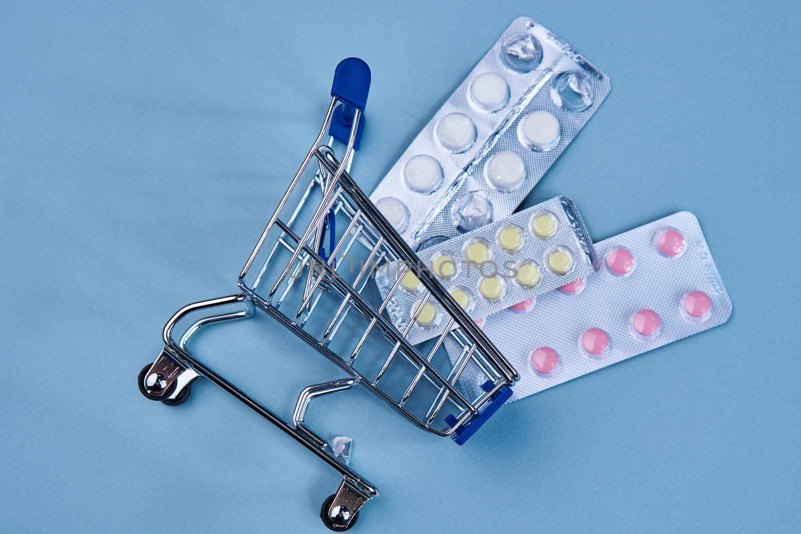 pill cart shopping medicine pharmacy blue background. High quality photo