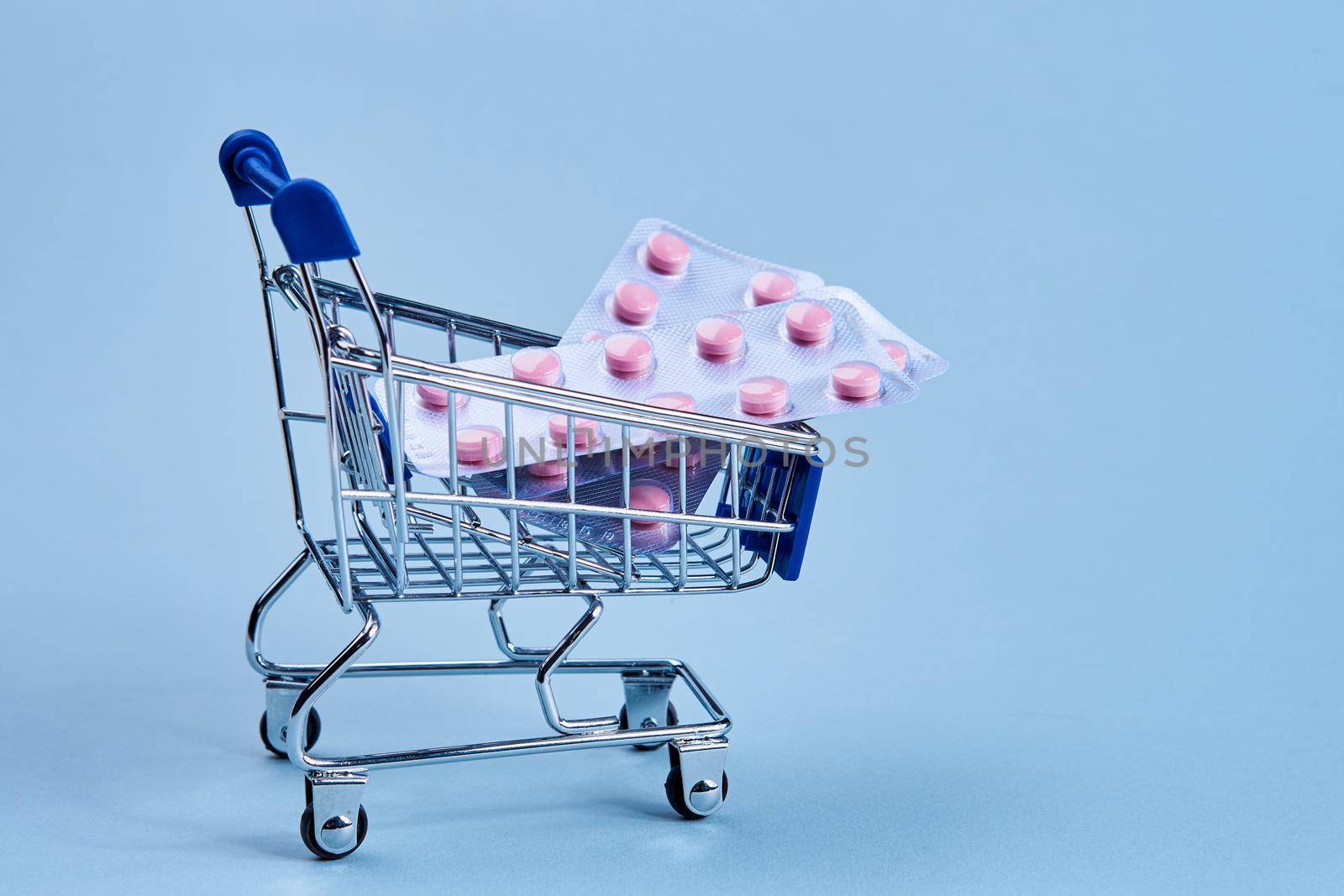packs of pills in a trolley shopping in a pharmacy medicines. High quality photo