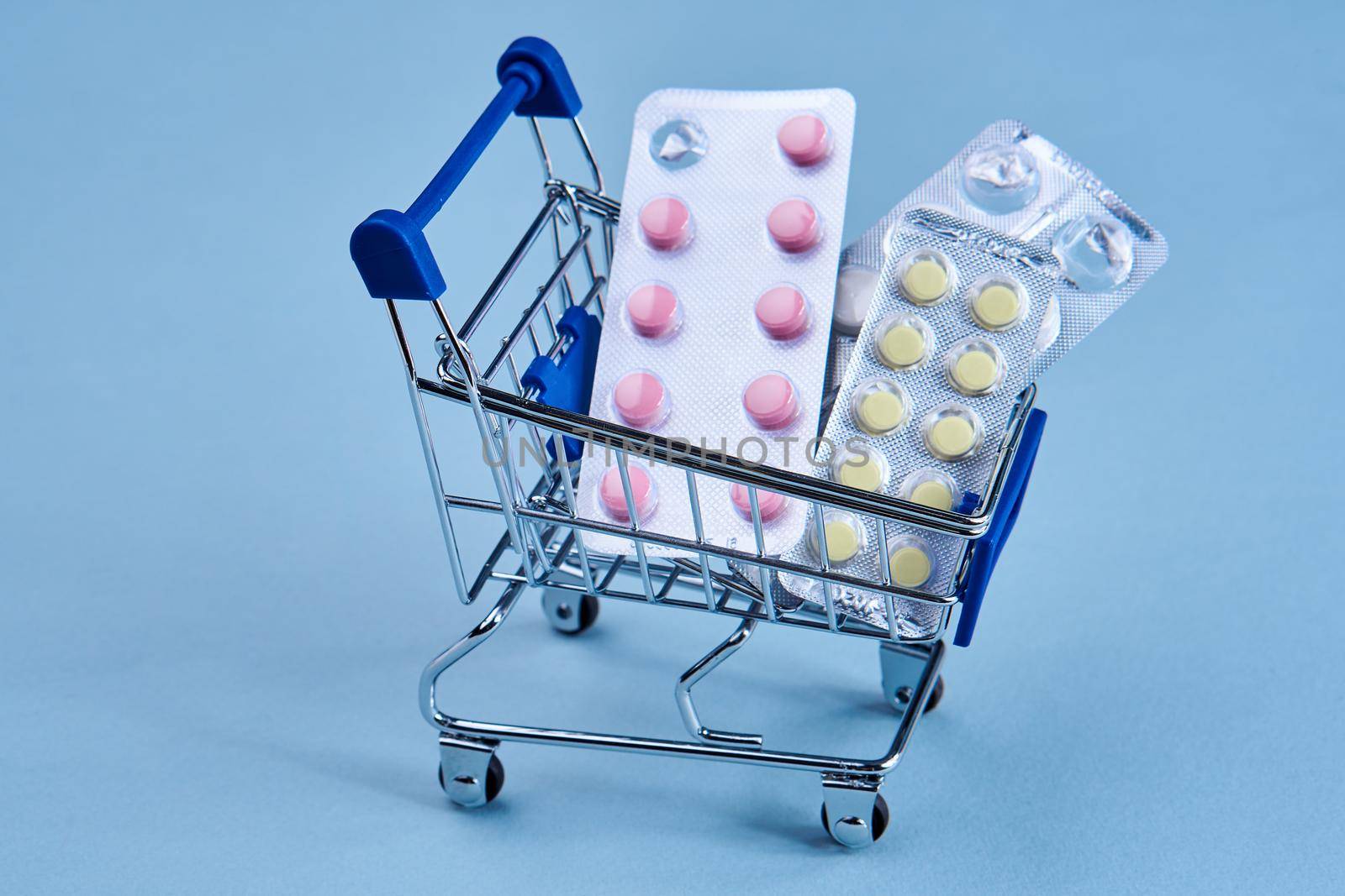 pill cart shopping medicine pharmacy blue background. High quality photo
