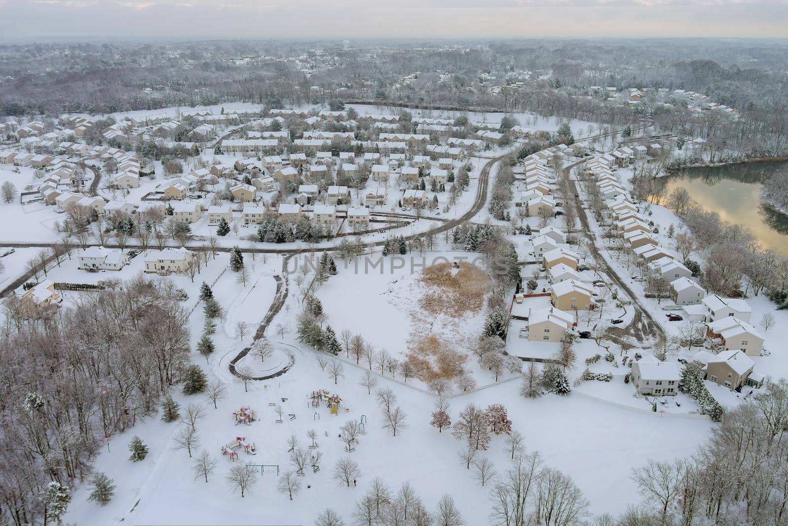 Aerial view of landscape small town with apartment complex covered in the wonderful winter scenery white snow by ungvar