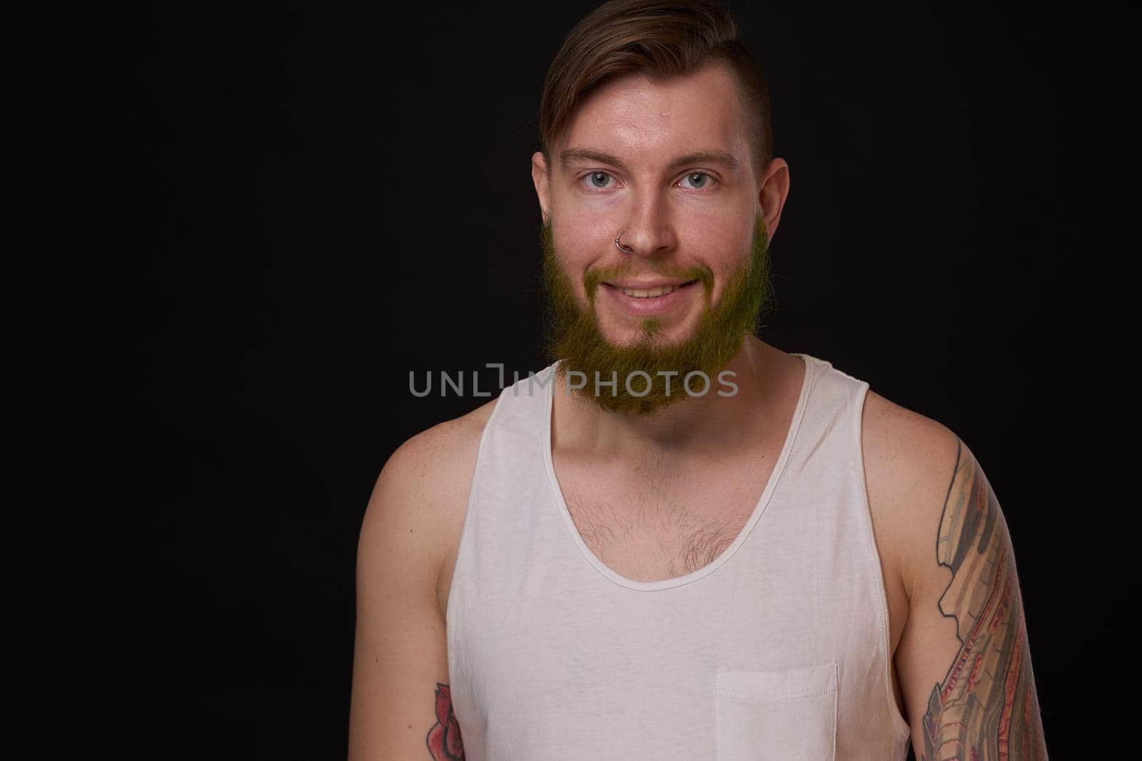 stylish bearded man in a white t-shirt with tattoos on his arms fashion by Vichizh