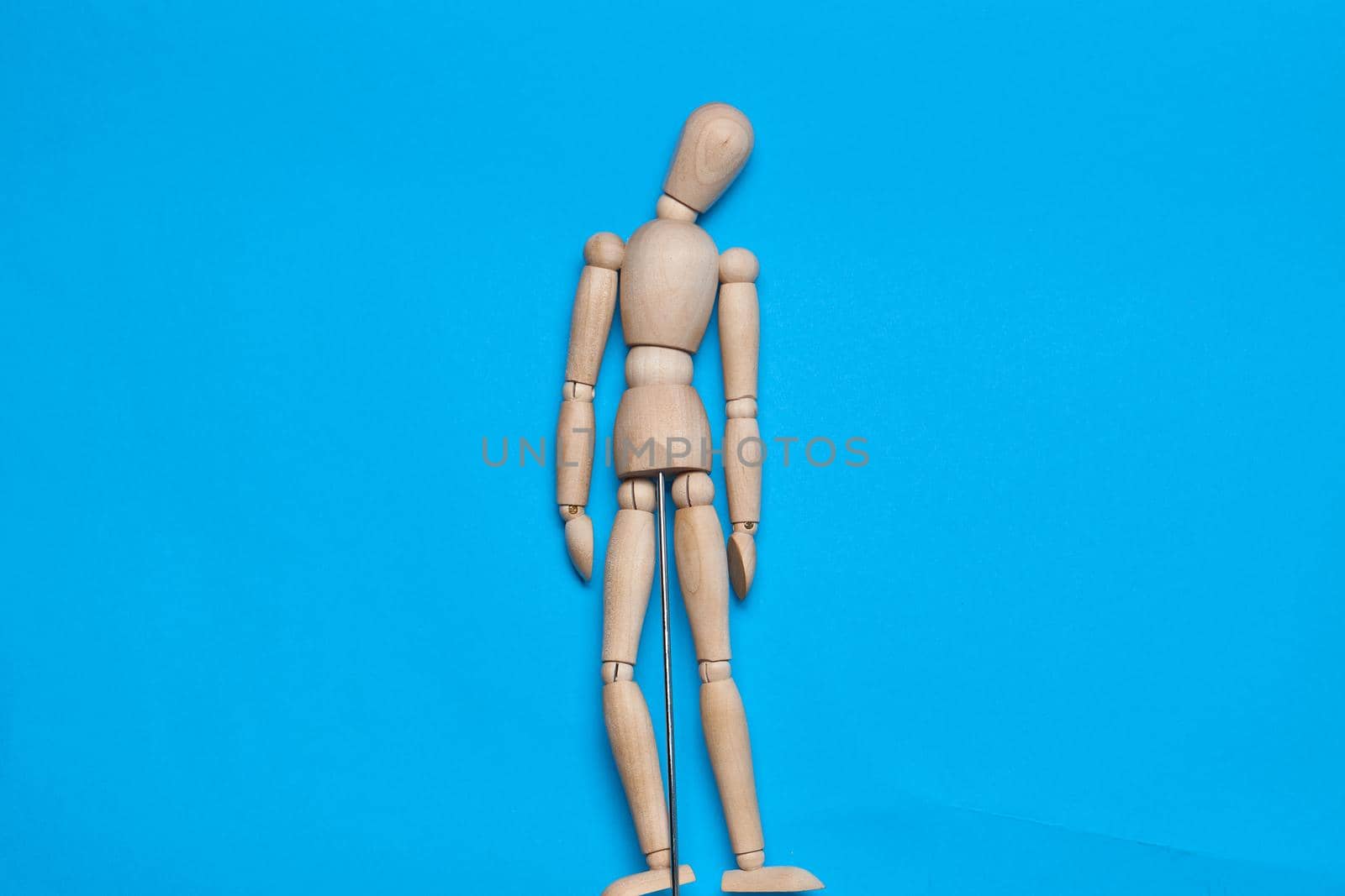wooden man mannequin blue background design object. High quality photo