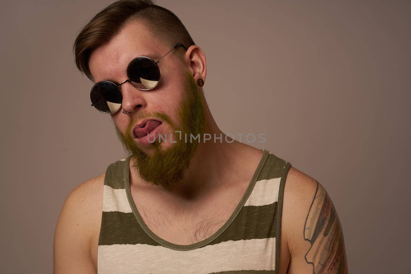 bearded man wearing sunglasses posing emotions isolated background. High quality photo