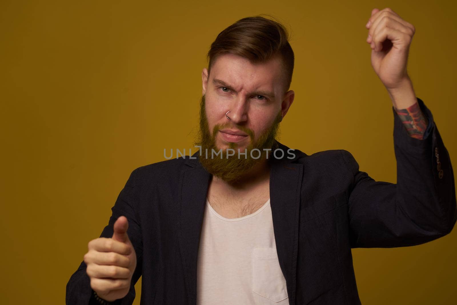 bearded man fashionable hairstyle jacket posing self confidence. High quality photo