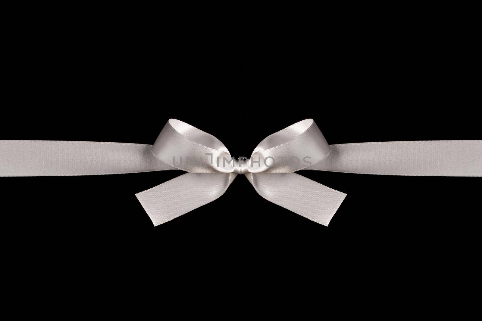 White ribbon bow on black background, black friday holiday gift