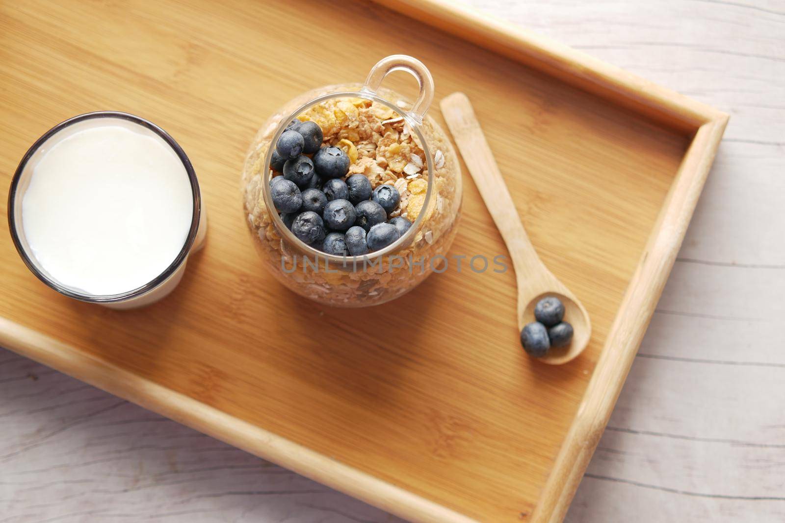 cereal breakfast and blue berry in bowl on table .