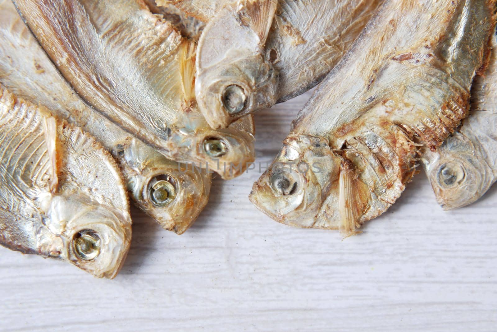 close up of dried fish on blue backgrund .