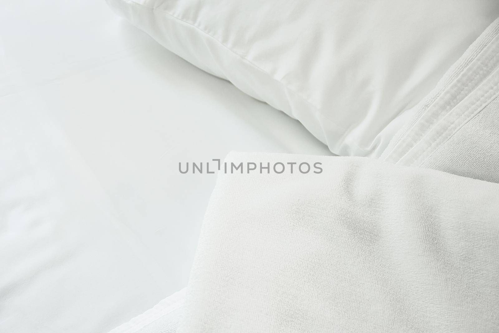 white towel on white mattress fabric, soft light in the morning