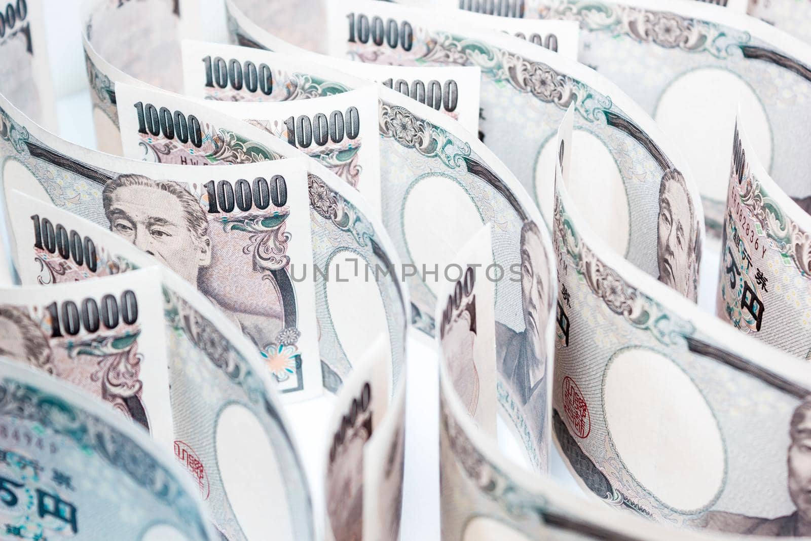 Wave Of Money Yen Banknote On White Background, Business And Finance Concepts, Banknotes Stacked On Each Other In Different Positions by rakoptonLPN