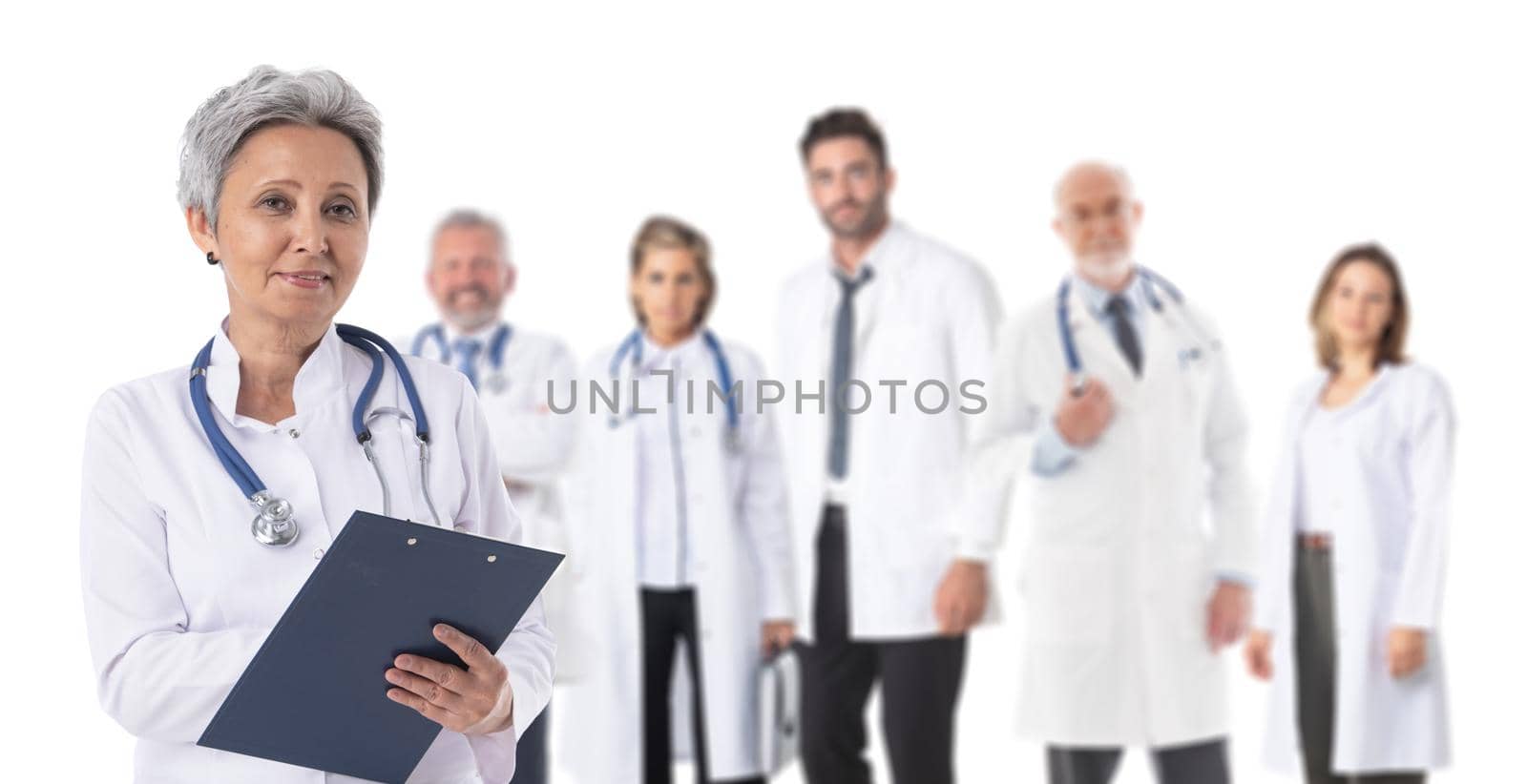 Team of doctors and asian mature female leader with folder in front isolated on white background