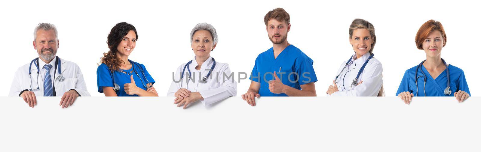 Photo of a medical team holding a blank poster with copy space for text, isolated over white background.