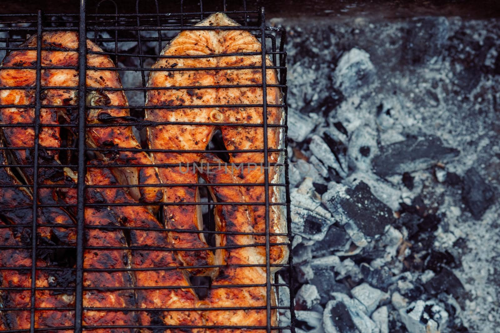 cooking fish outdoors barbecue close-up charcoal meal. High quality photo