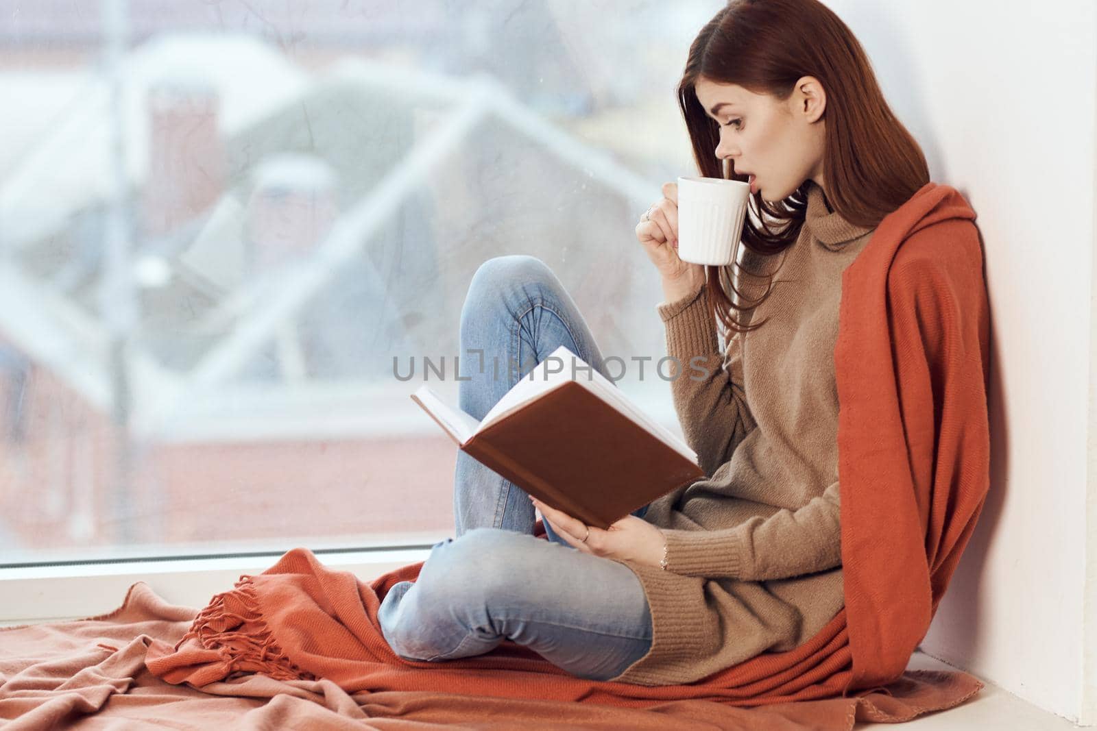 woman looking out the window on the windowsill Comfort weekend rest. High quality photo