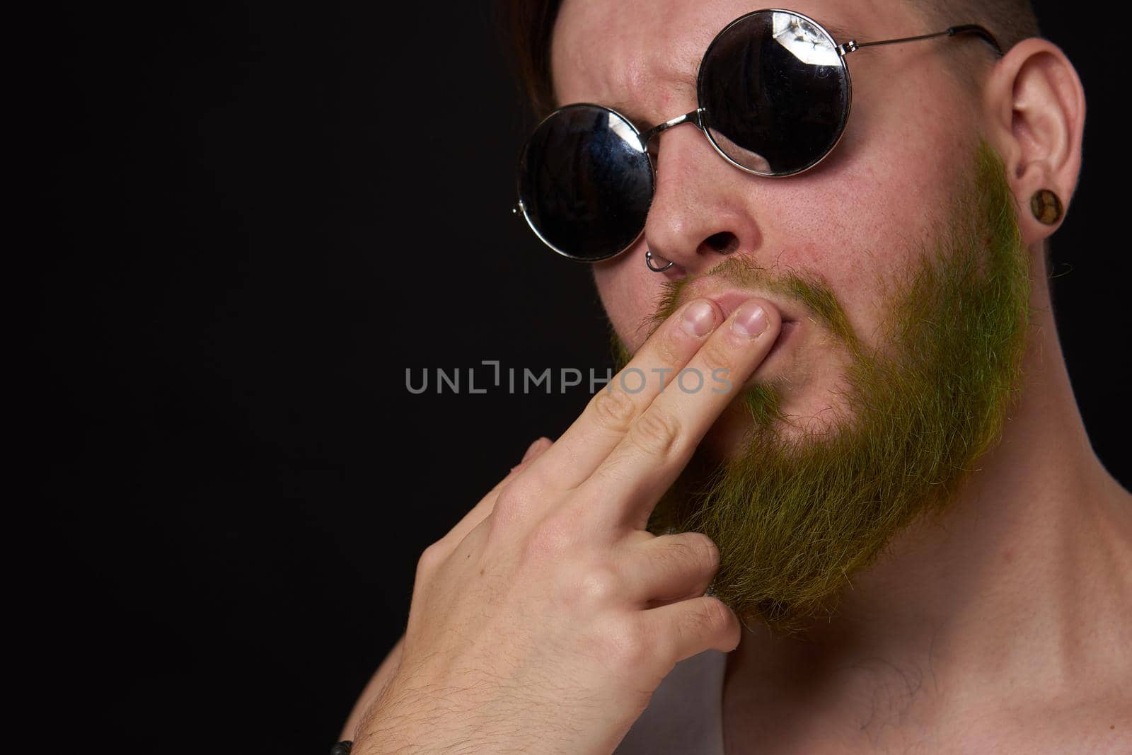 cheerful bearded man in white t-shirt sunglasses posing. High quality photo