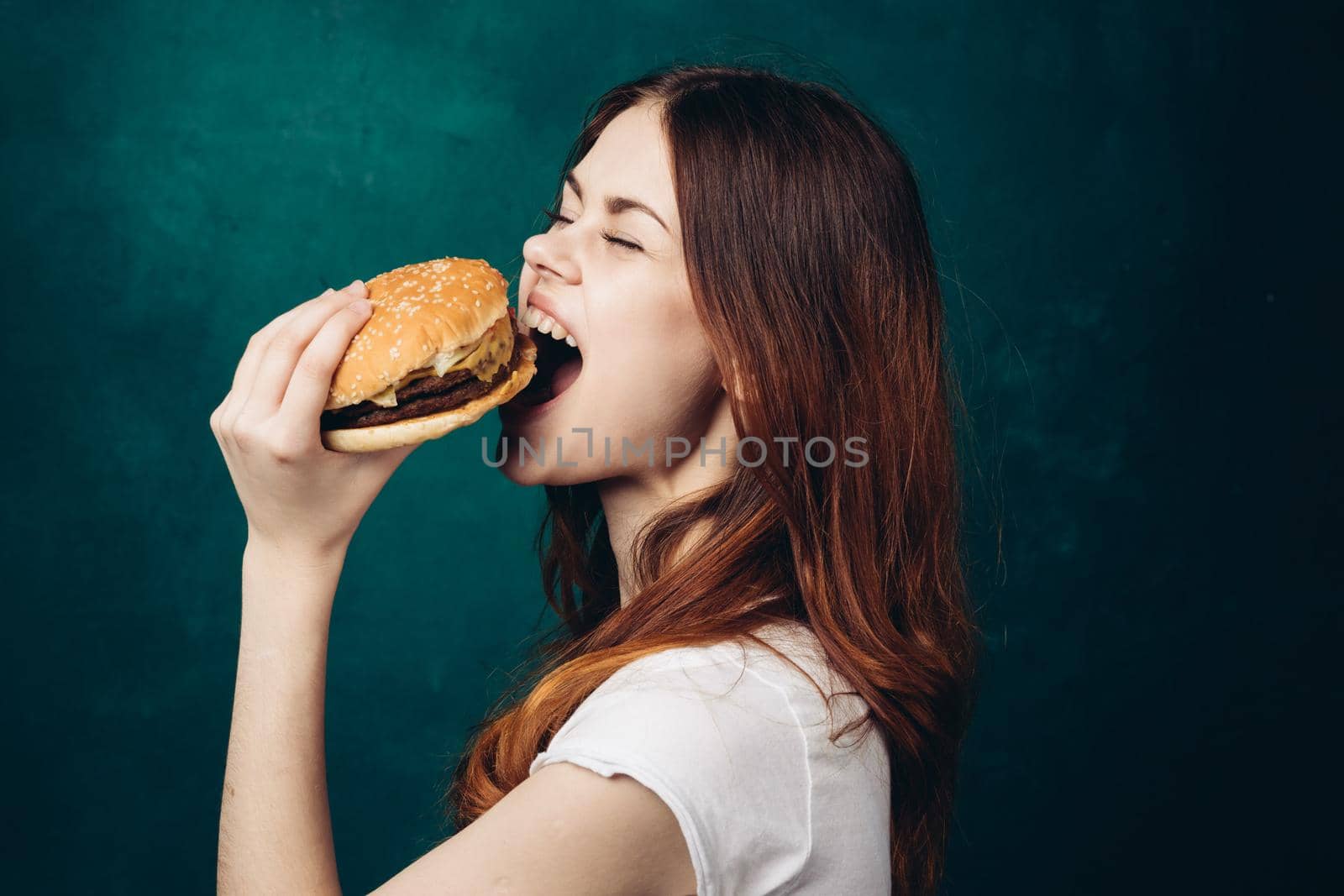 cheerful woman eating hamburger snack close-up lifestyle. High quality photo