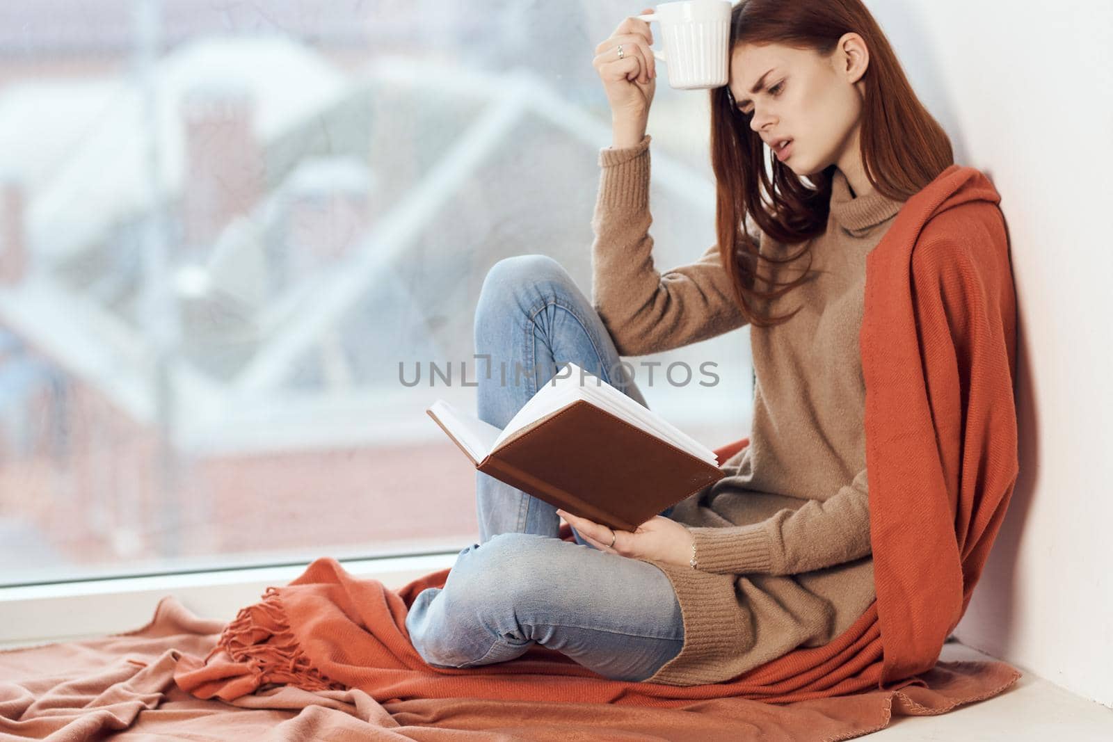 woman looking out the window on the windowsill Comfort weekend rest. High quality photo