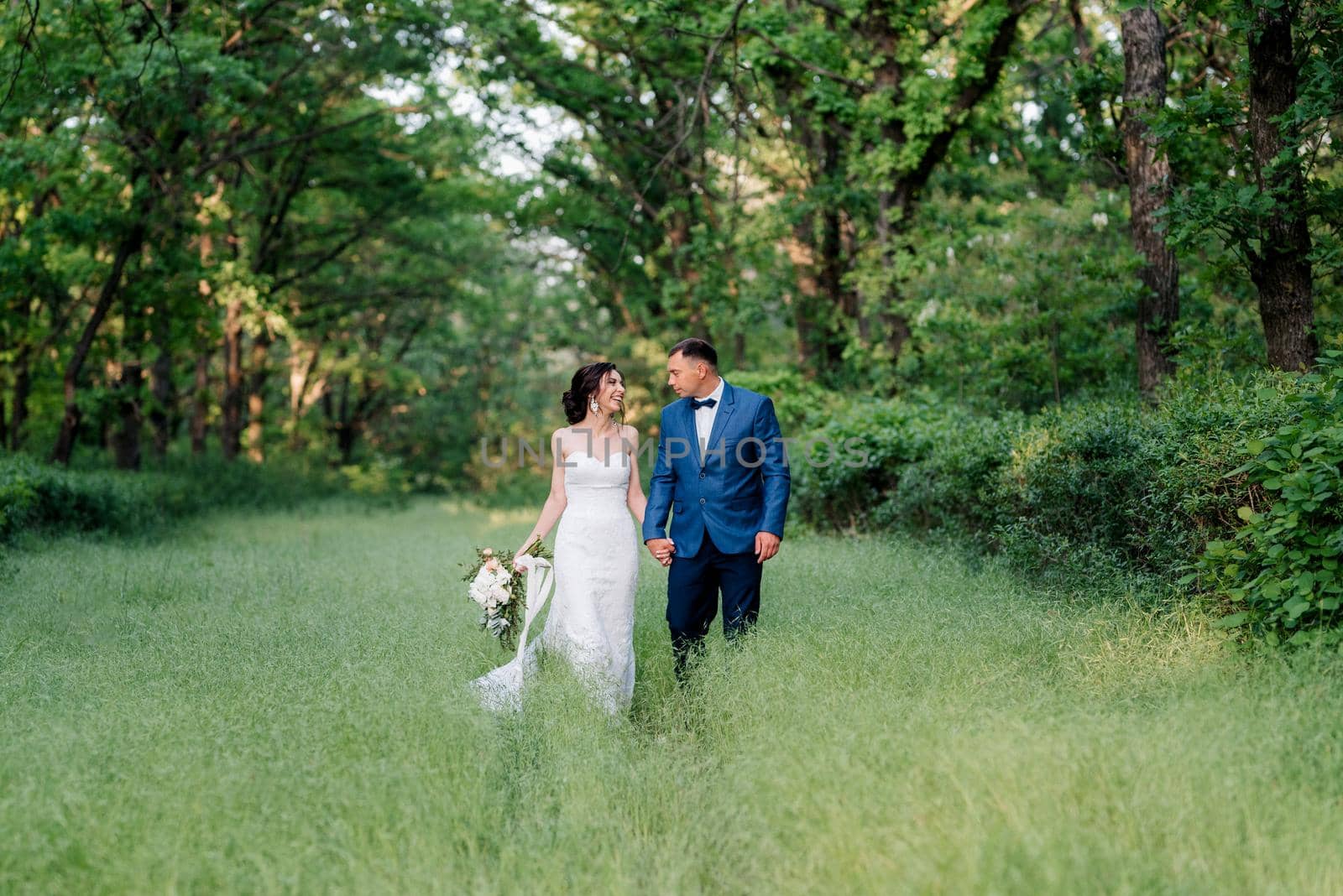 A couple in love a guy and a girl on a walk in the forest belt