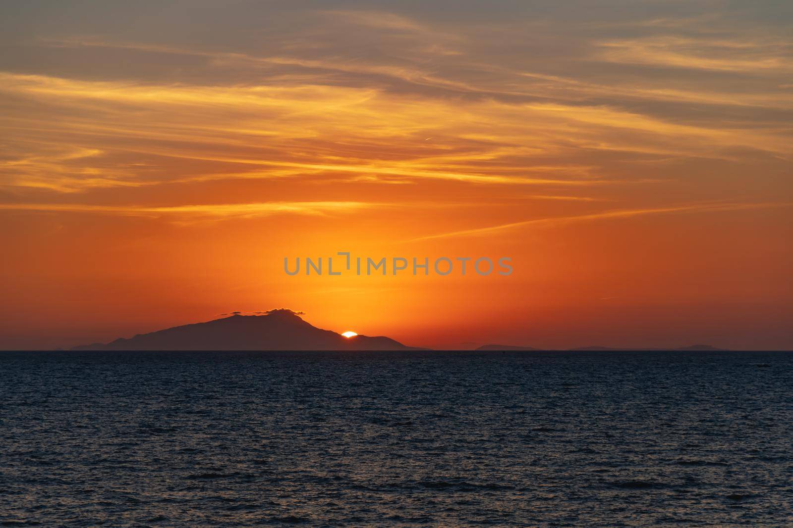 Beautiful sunset with sun hiding behind Ischia island over Tyrrhenian Sea by Wierzchu