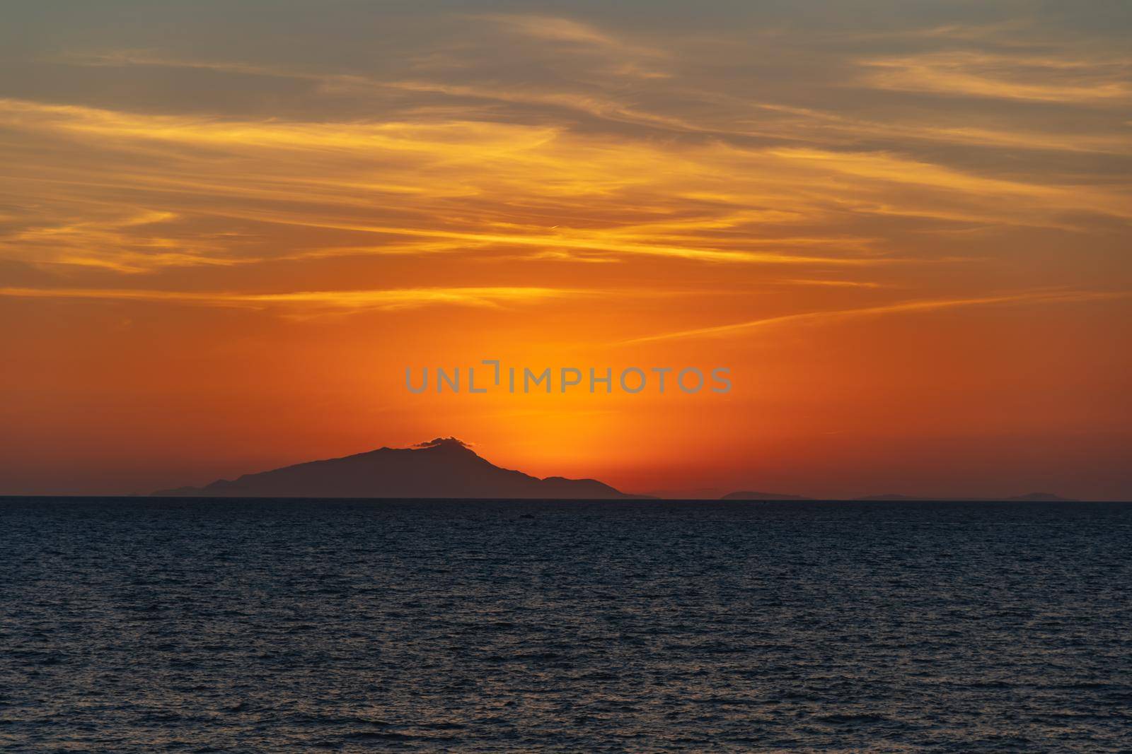 Beautiful sunset with sun hiding behind Ischia island over Tyrrhenian Sea by Wierzchu