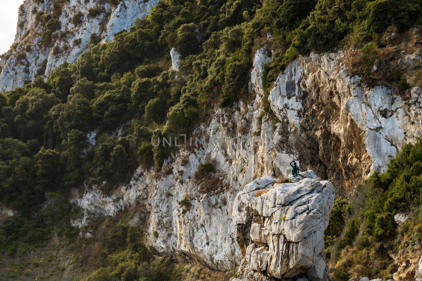 Rock formations full of trees and bushes at hills of Capri island