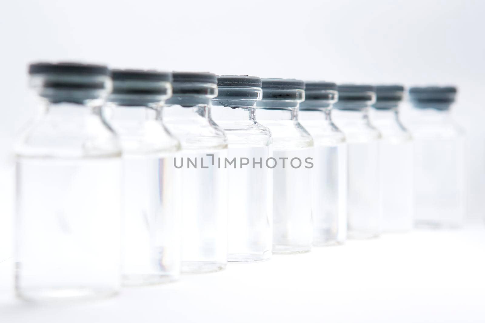 a bottle of vaccine on a white background by titipong