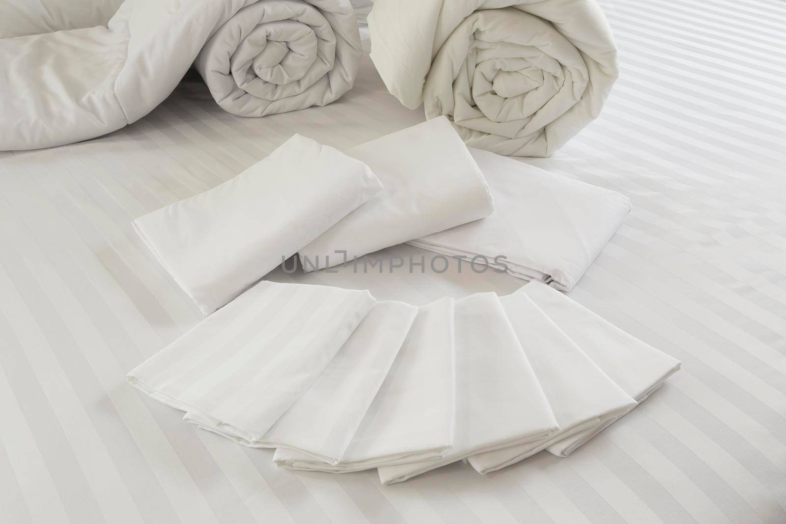 White pillowcase on white bed