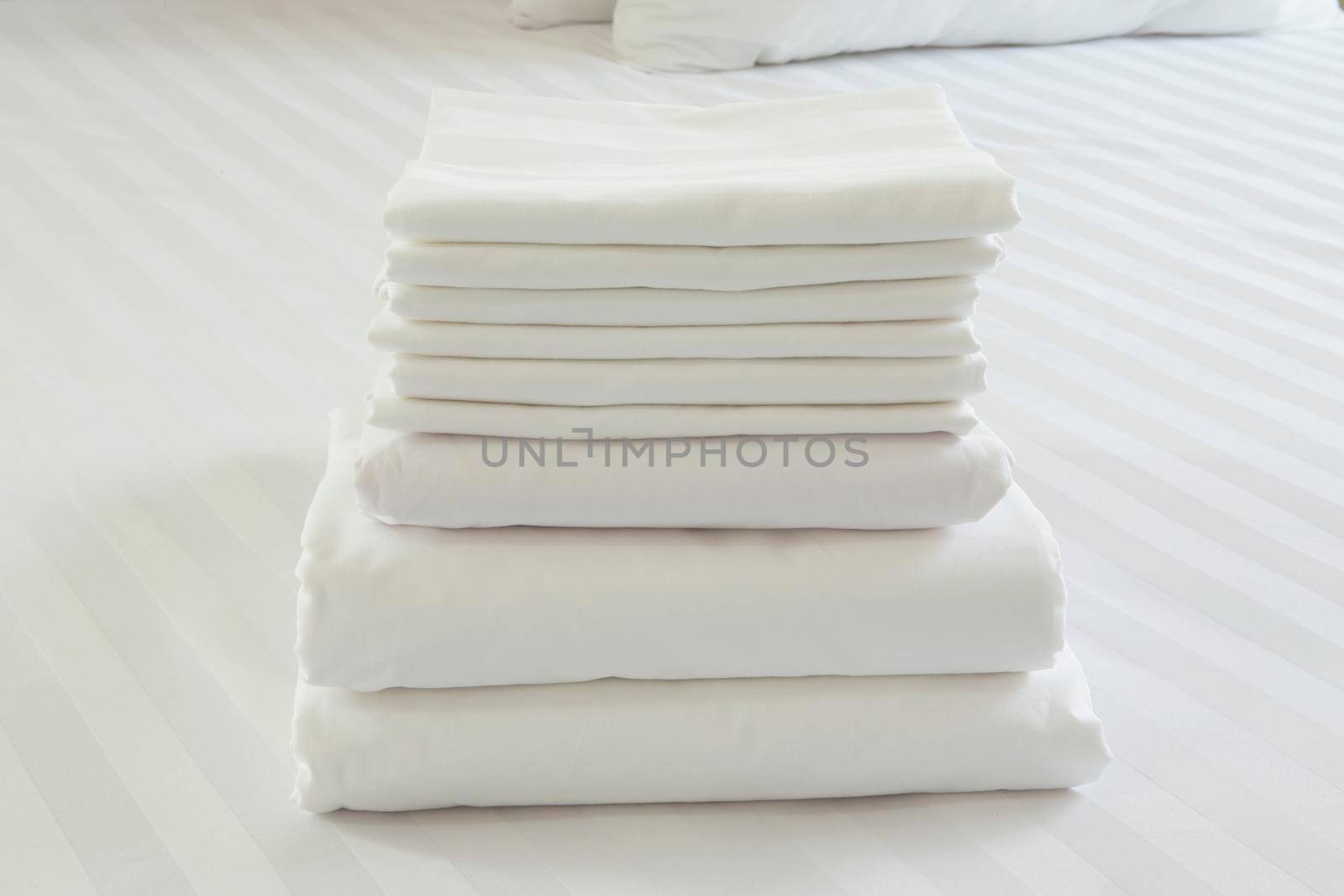 White pillowcase on white bed