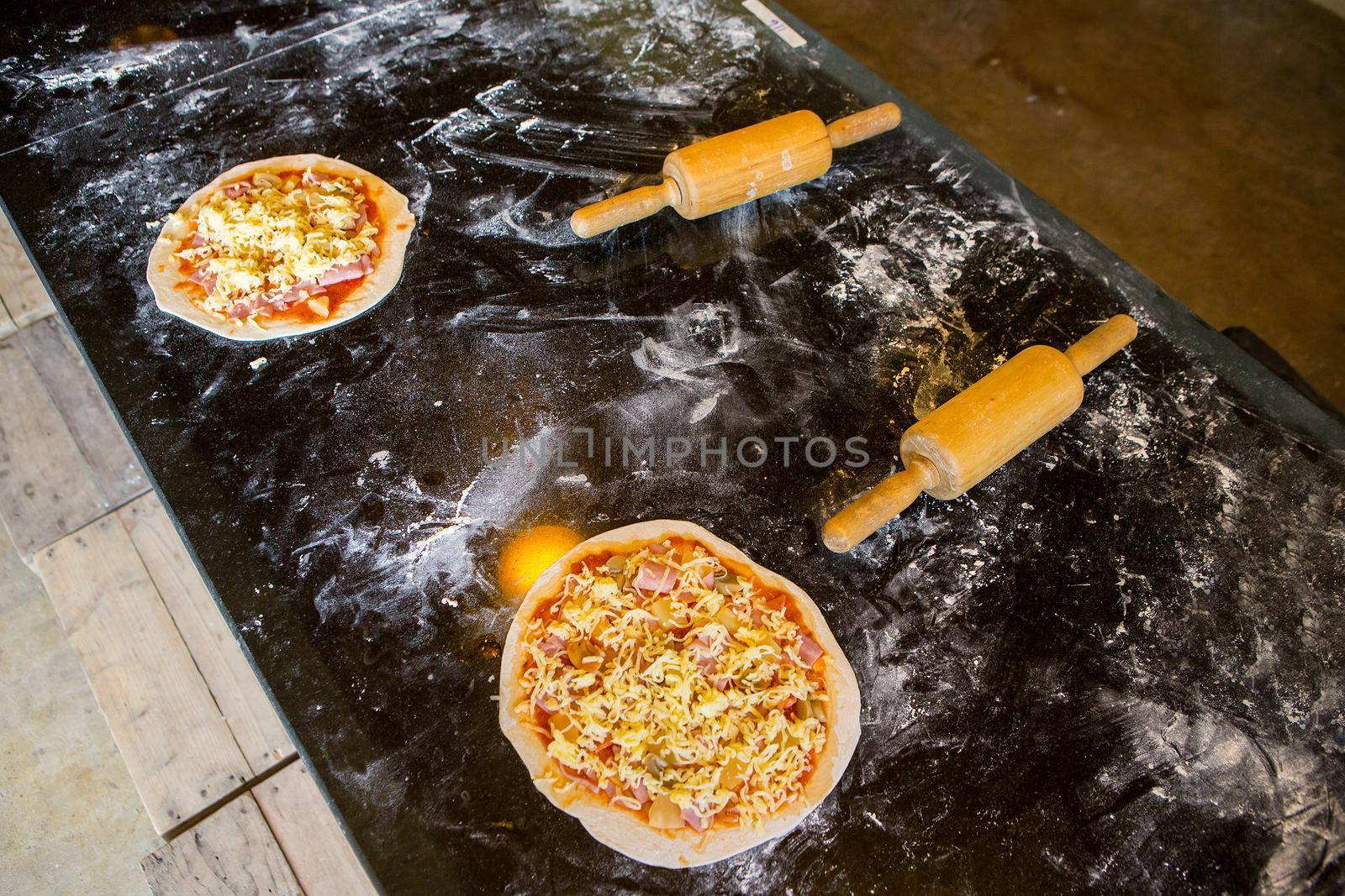 making pizza at kitchen