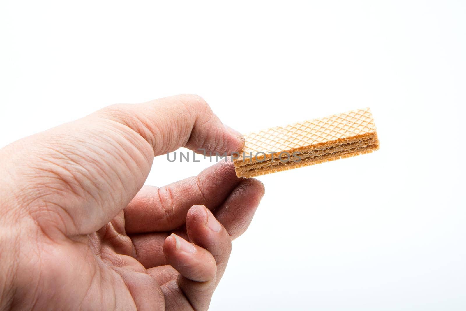 Hand holding a delicious wafer.