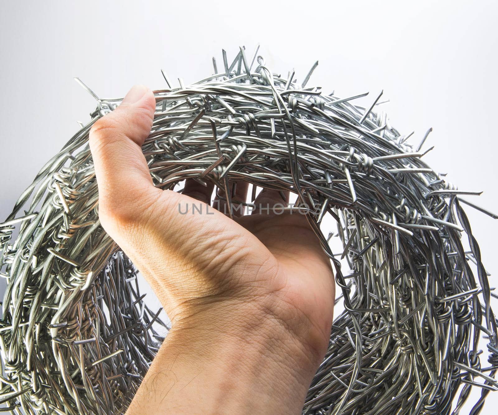 A roll of barbed wire over white background