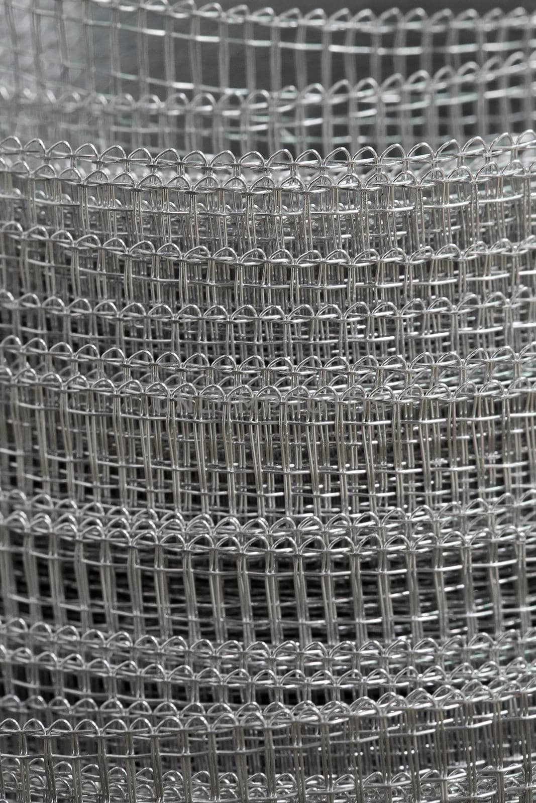 Background. Roll of a metal grid close up.