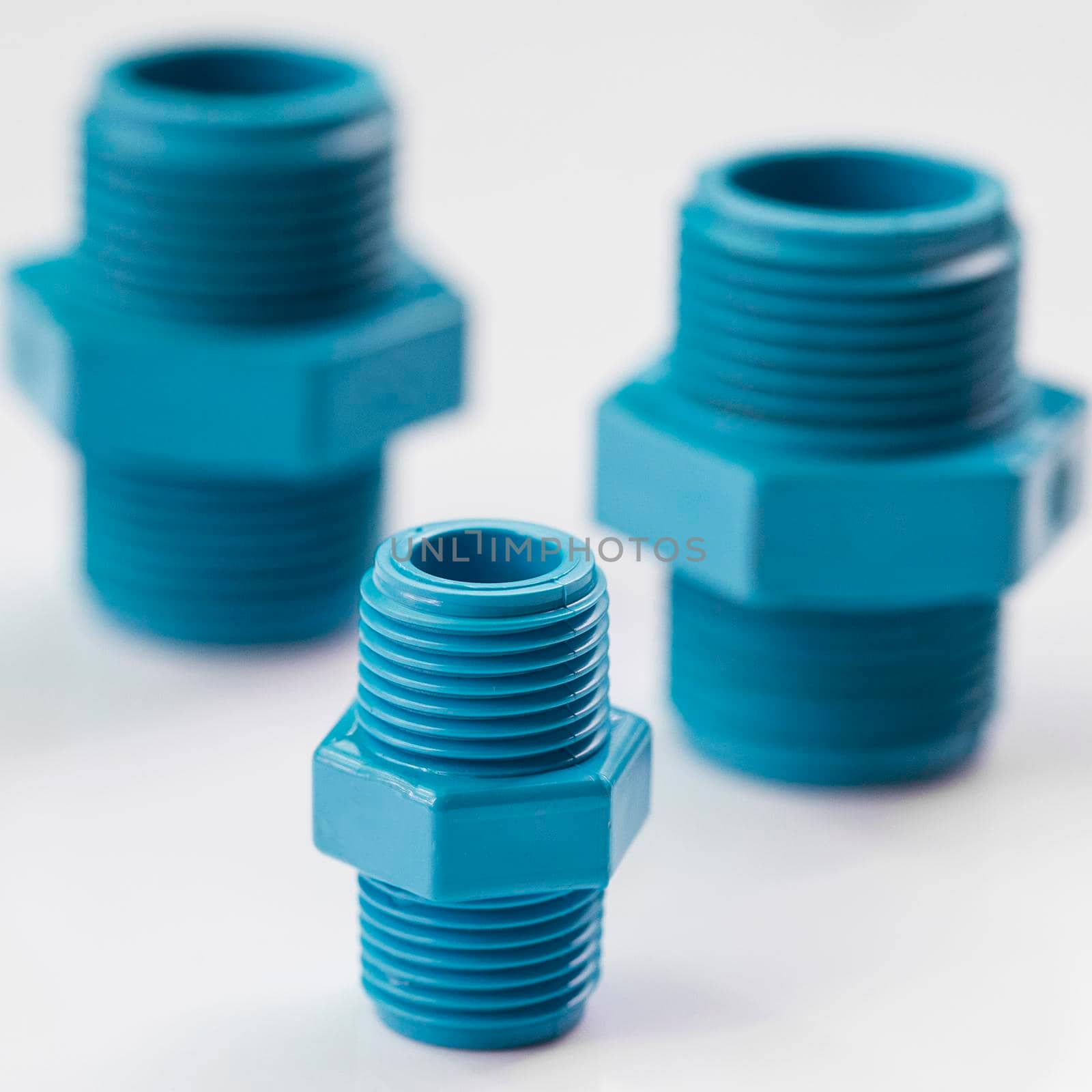 PVC pipe fittings on white background.