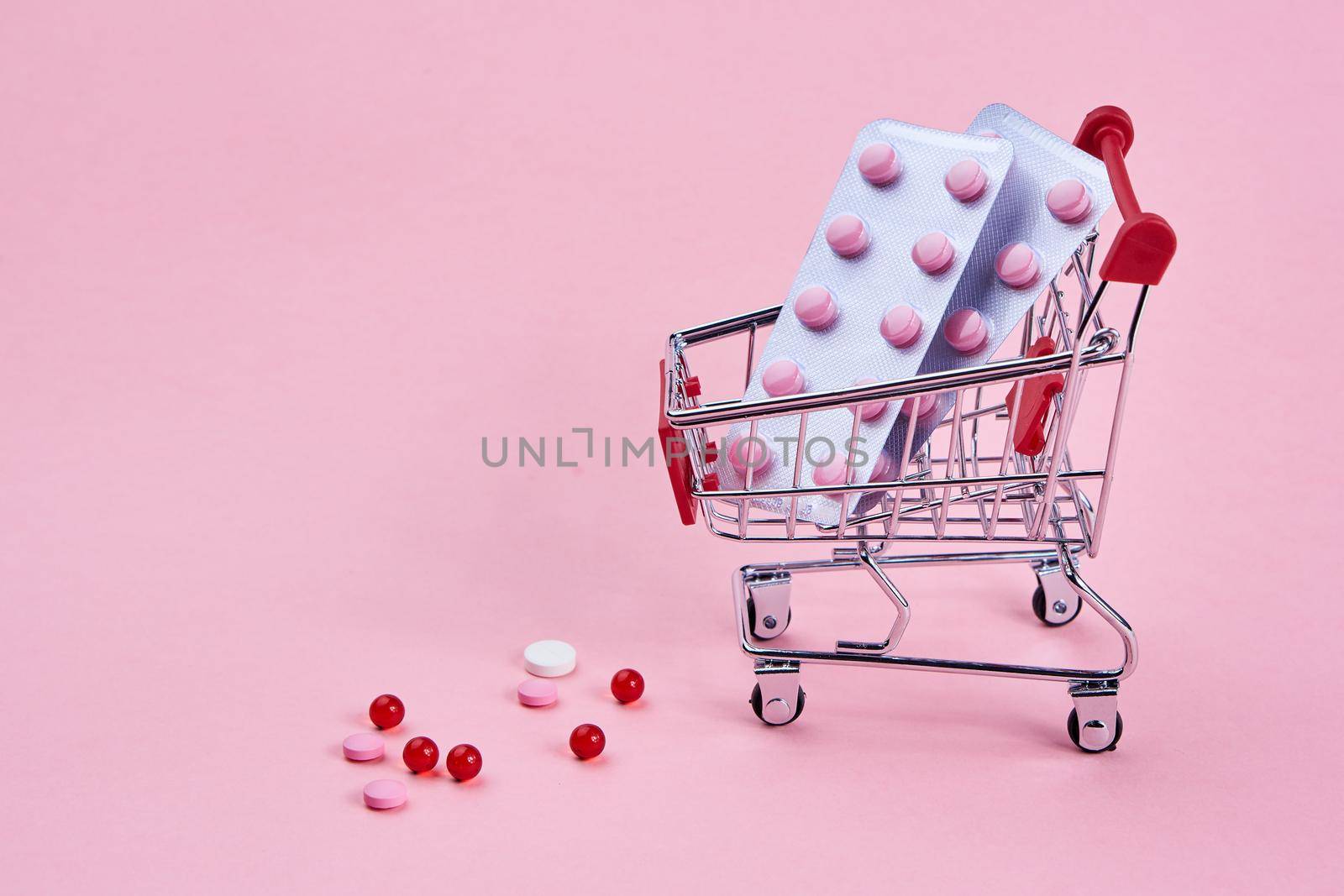 small cart with a pack of drugs pharmacy shopping service medicine. High quality photo