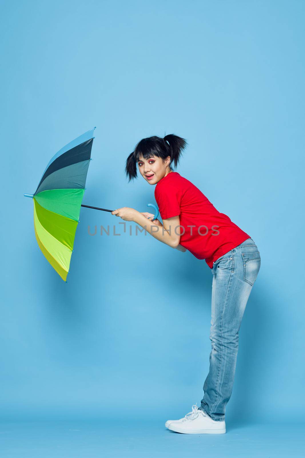 cheerful woman in red t-shirt rainbow color umbrella fashion. High quality photo