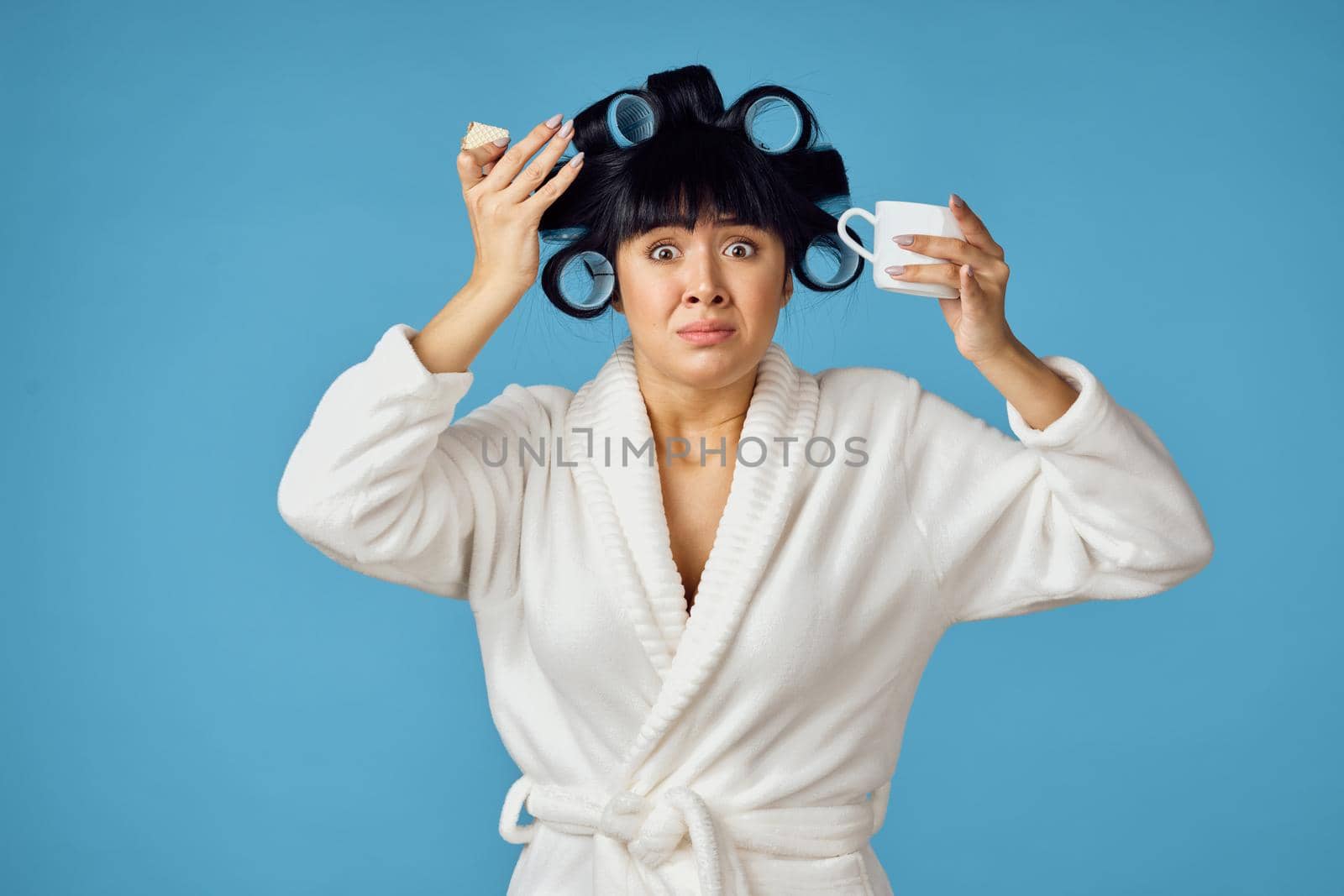 Woman in white robe housework cleaning service blue background. High quality photo