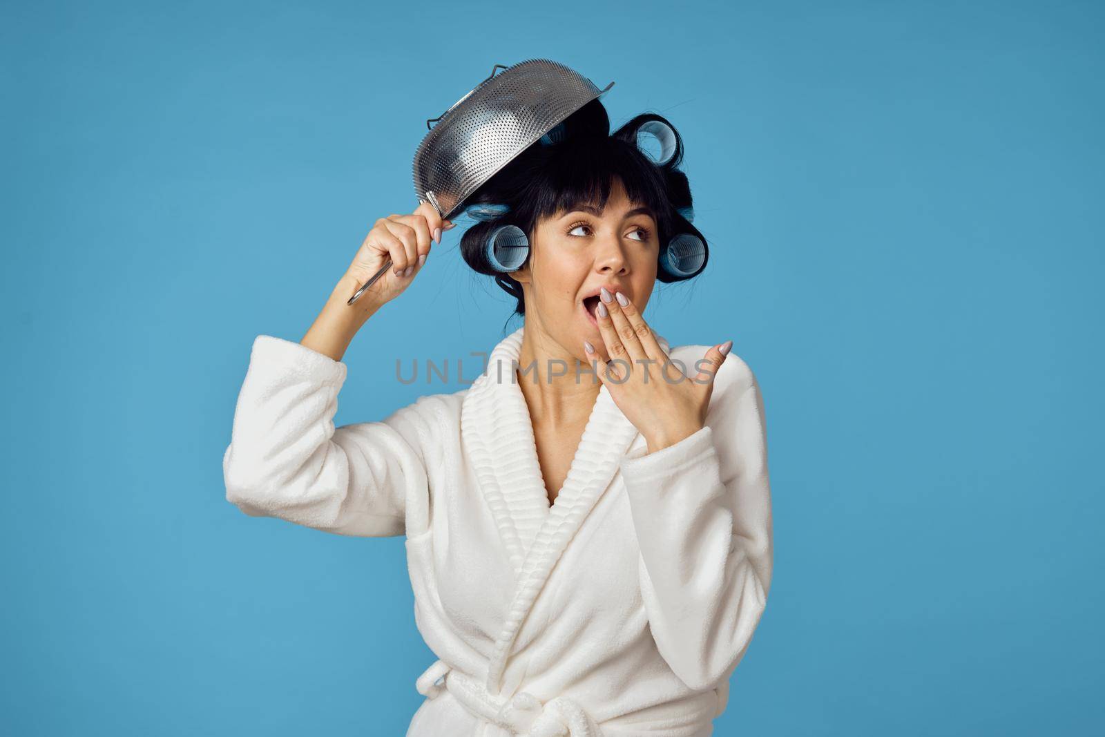 housewife in white coat housework cleaning blue background. High quality photo