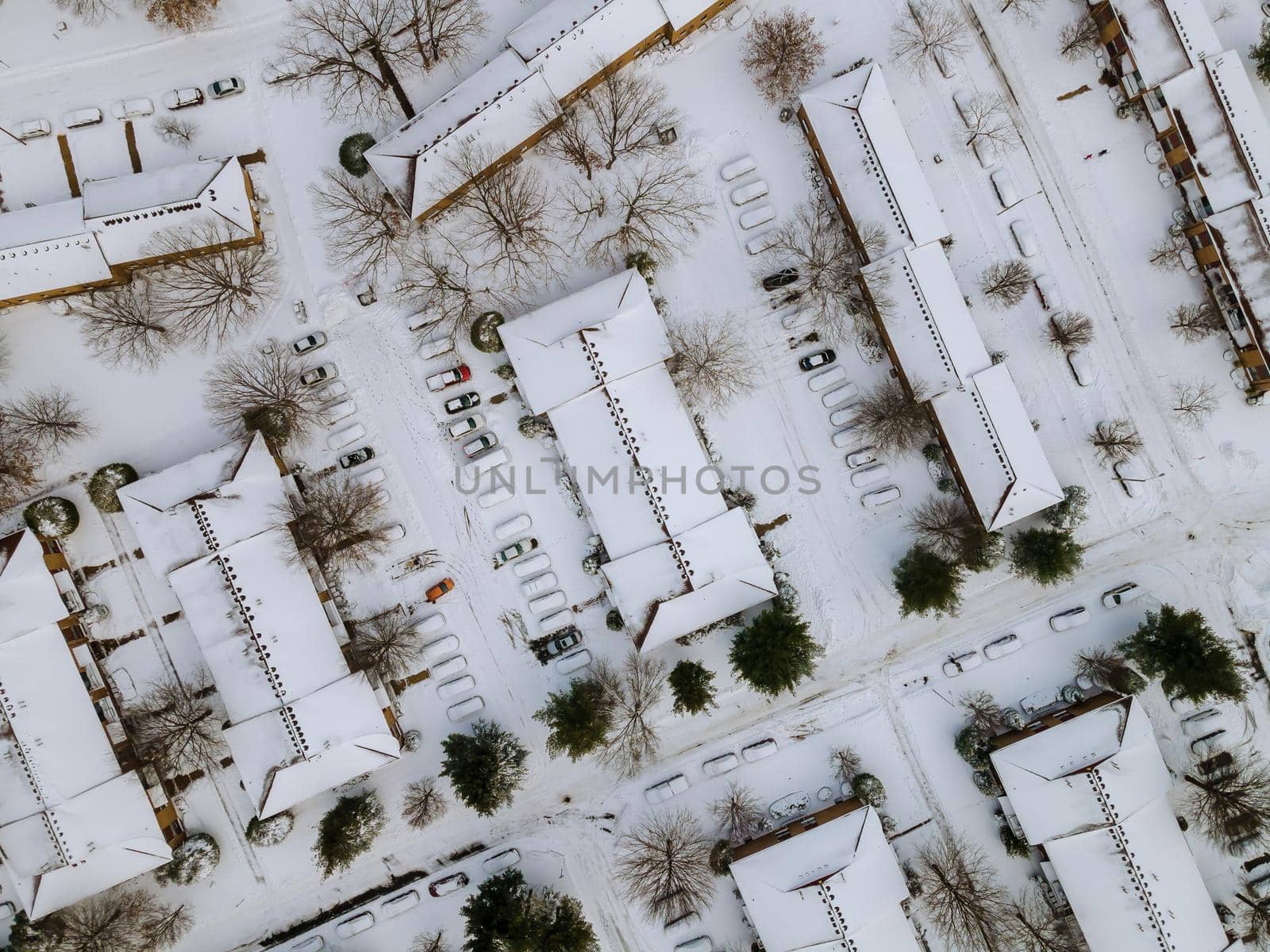 Aerial view winter landscape American town small apartment complex of a snowy winter on the streets after snowfall by ungvar