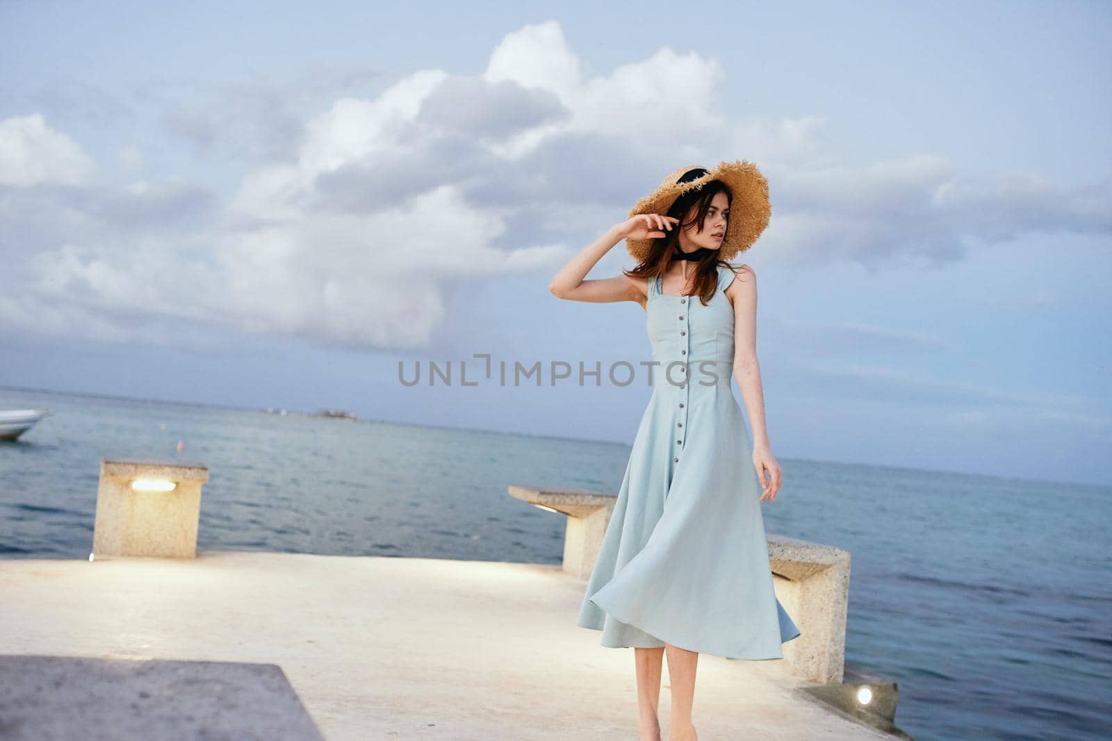 woman in dress near ocean beach summer lifestyle leisure. High quality photo