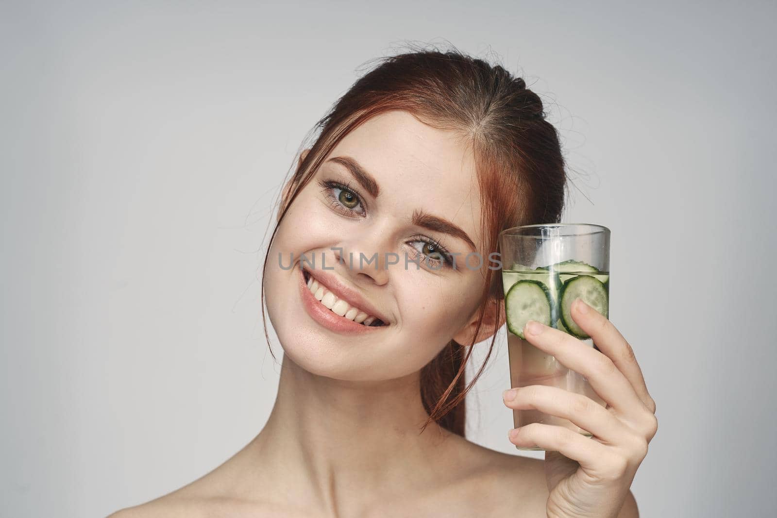 woman with cucumber drink health vitamins close-up by Vichizh