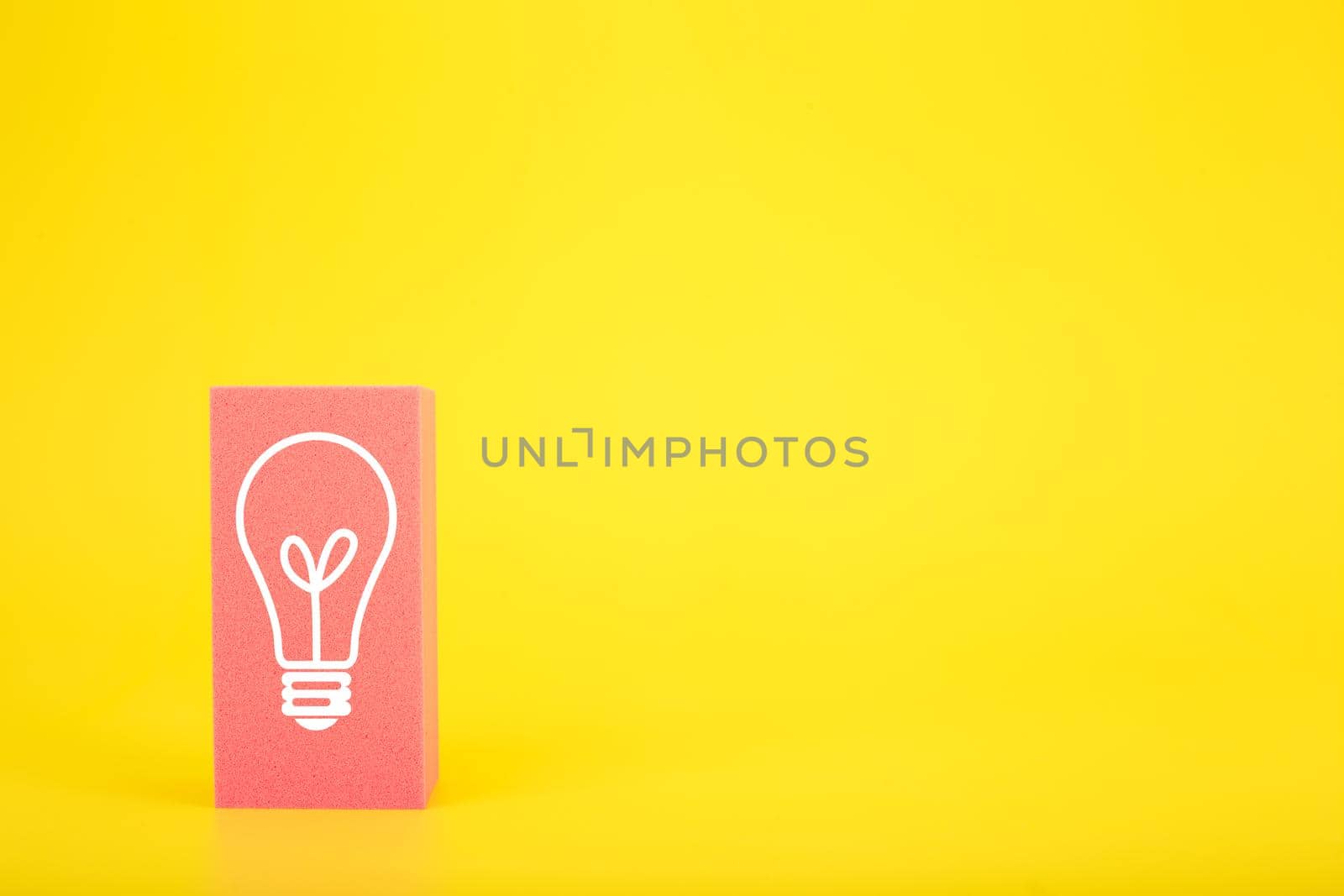 Concept of idea, creativity, start up or brainstorming. White drawn light bulb on pink rectangle against yellow background with copy space