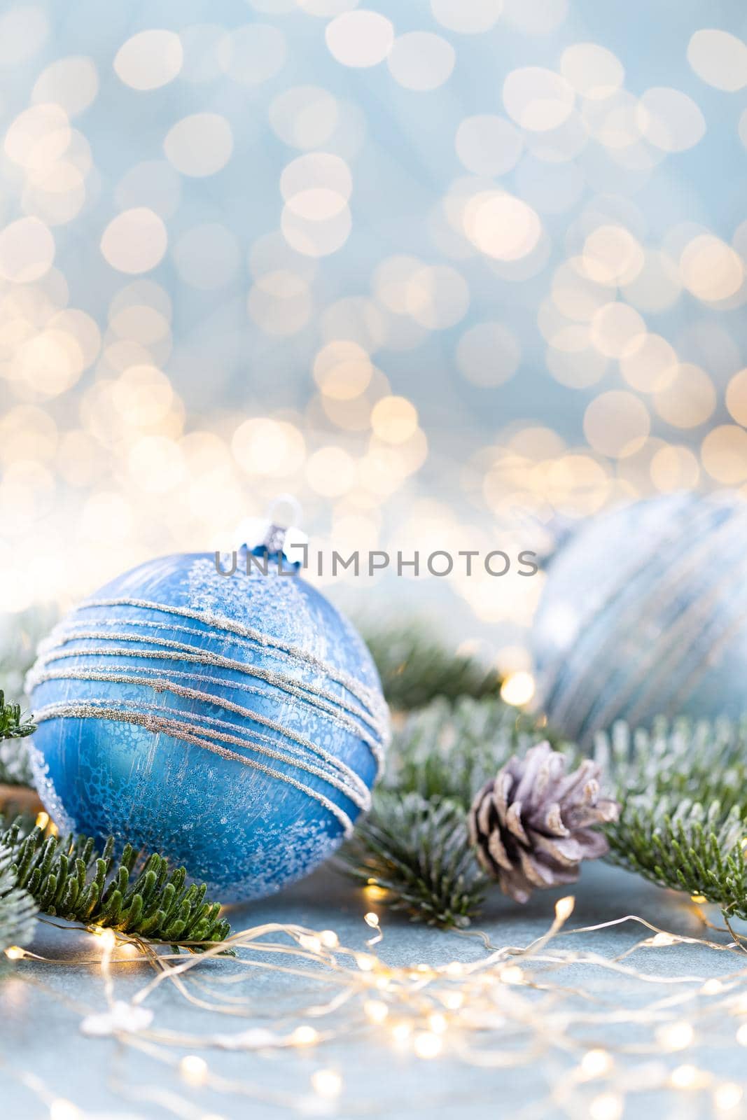 Christmas spruce with ball and blurred shiny lights.