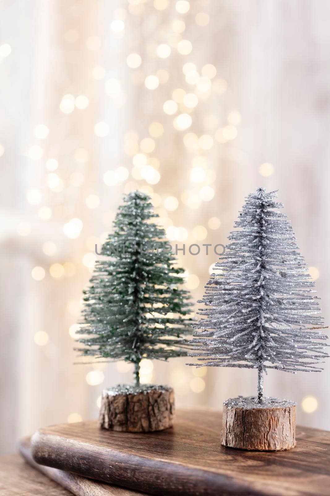 Christmas tree on wooden, bokeh background. Christmas holiday celebration concept. Greeting card.