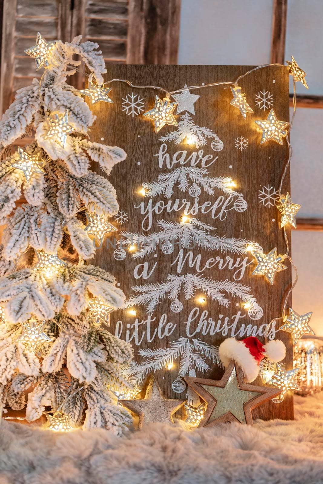 Board with Merry Christmas message on wooden background.