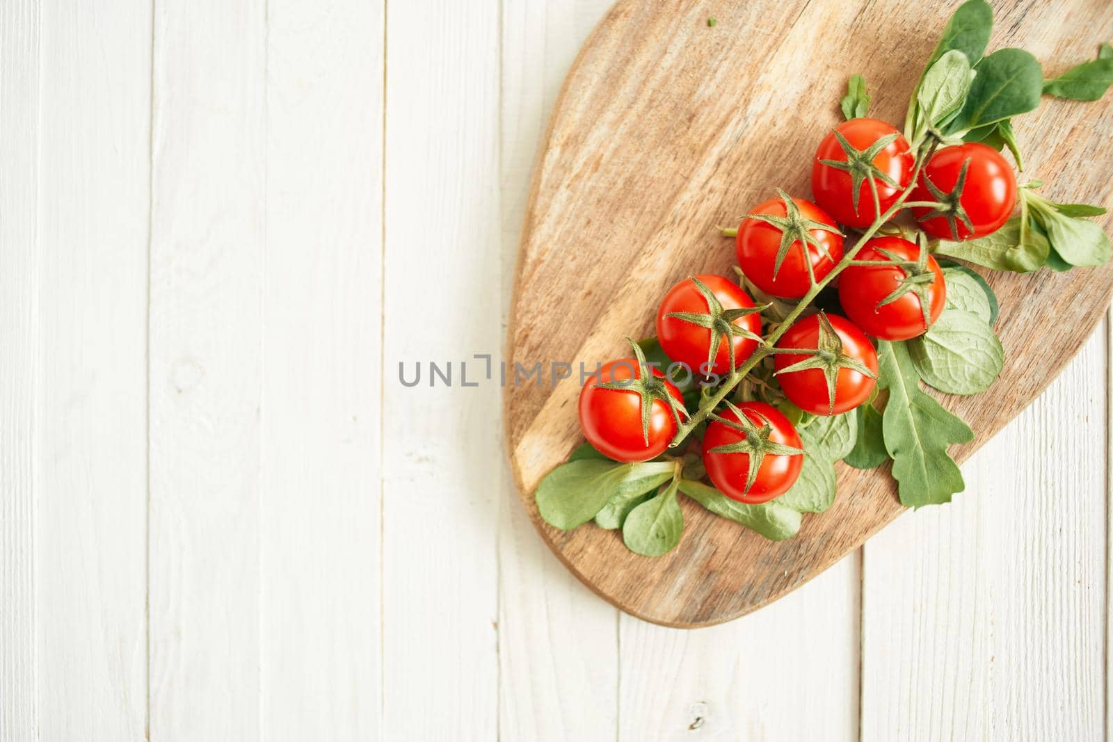 cherry tomatoes lettuce leaves wooden board fresh food. High quality photo