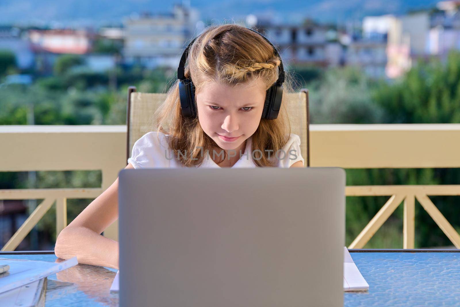 Girl child 10, 11 years old studying at home online by VH-studio