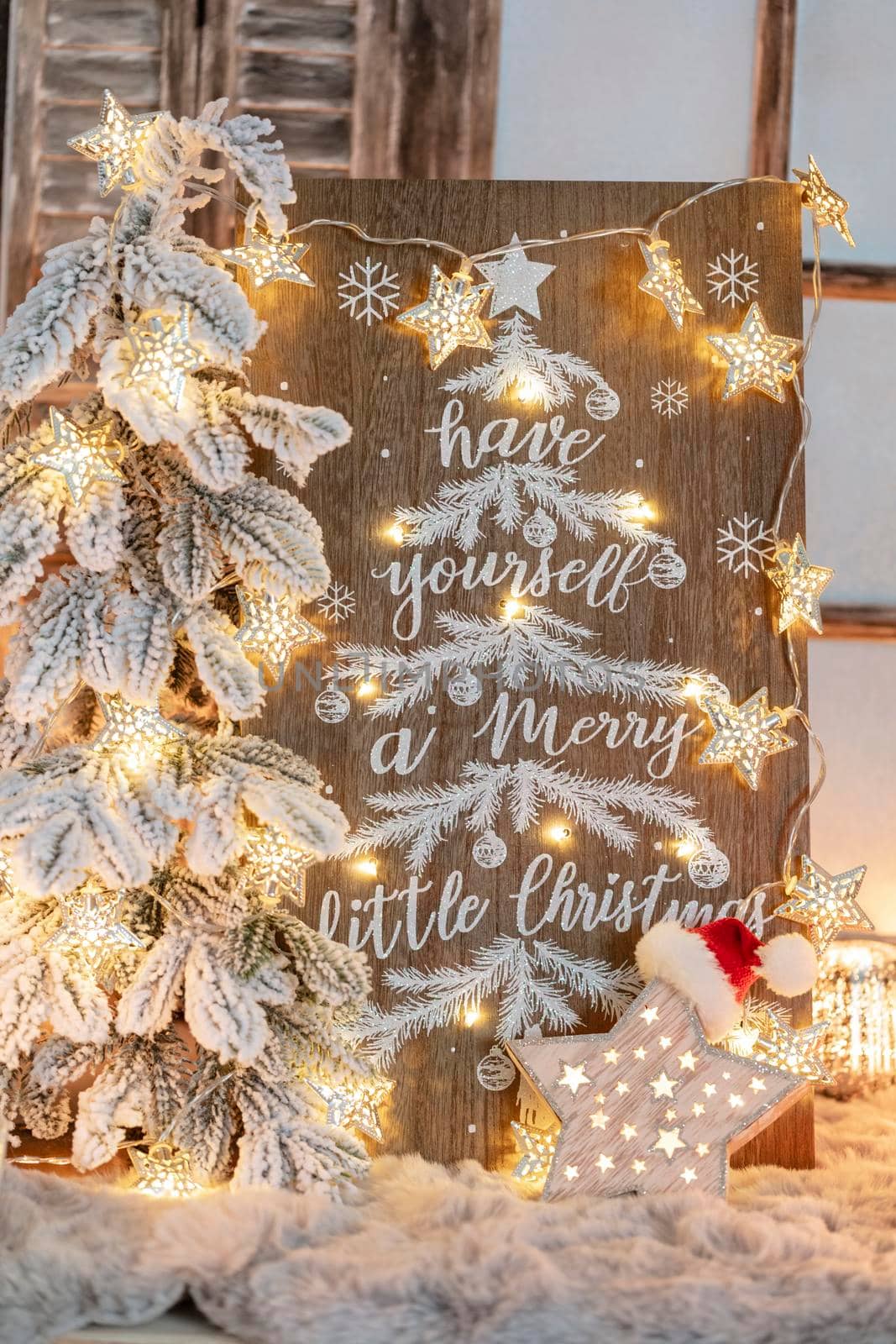 Board with Merry Christmas message on wooden background.