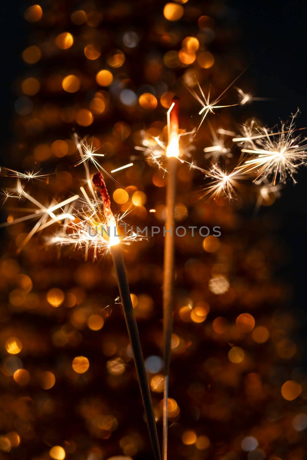 Christmas bengal fire sparkles against the black background. by gitusik