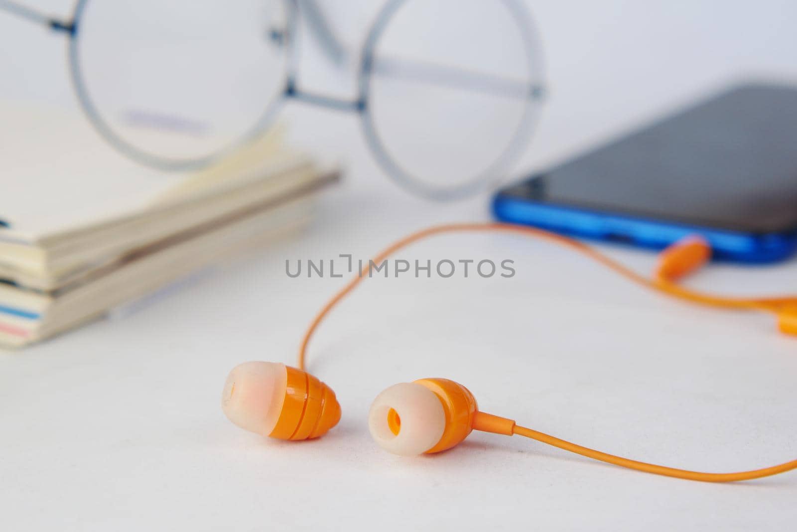 smart phone and headphone on wooden background