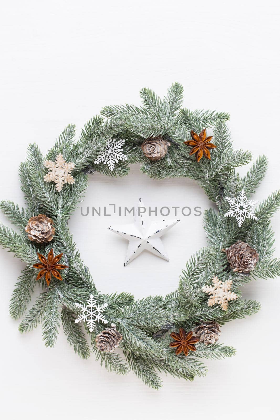 Christmas greeting card. Wreath decoration on white wooden background. New Year concept. Copy space.  Flat lay. Top view.