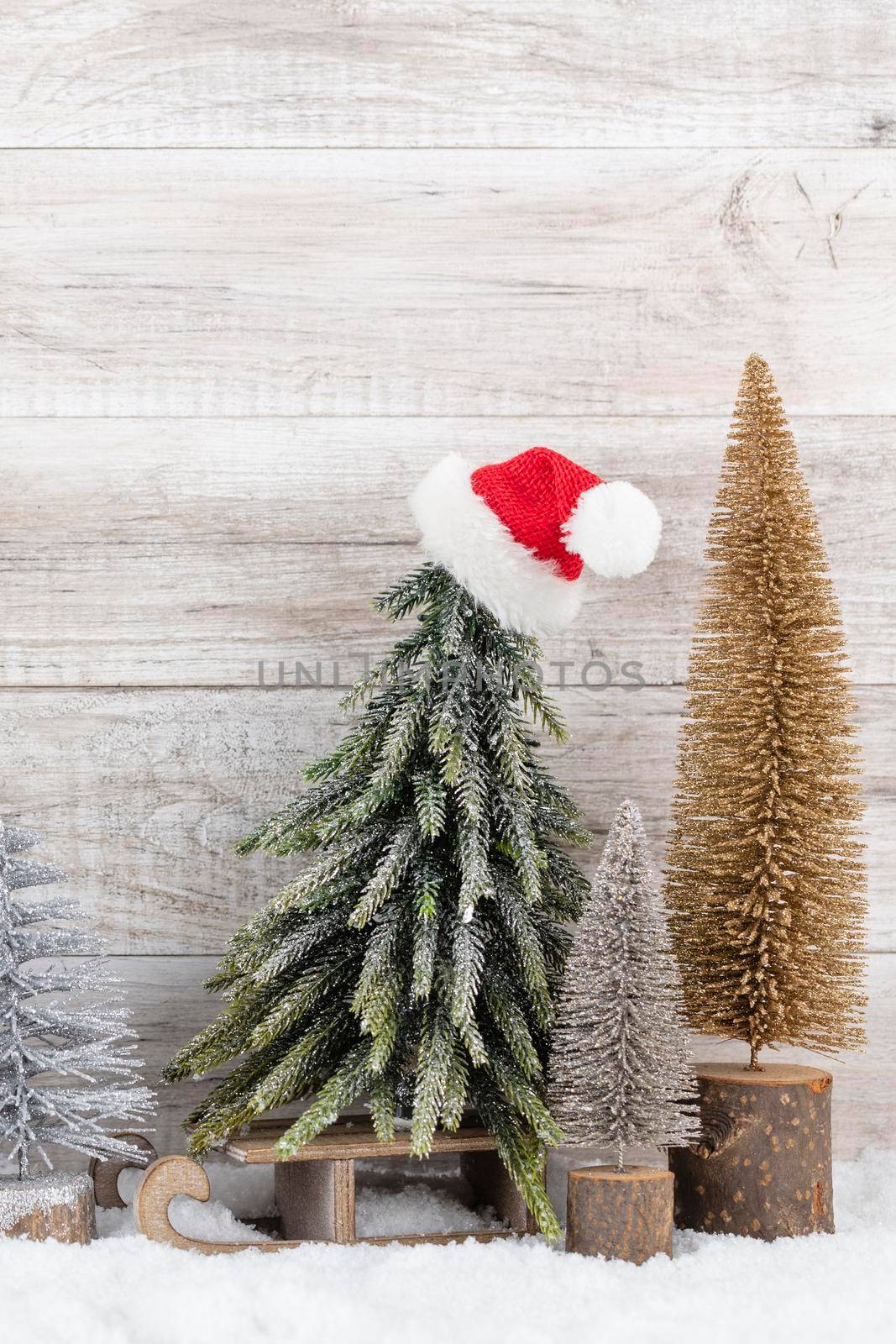 Christmas tree on wooden background.  by gitusik